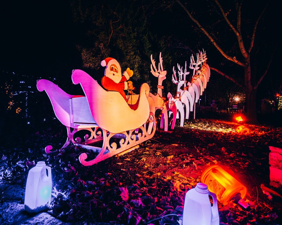 A lighted, wooden cutout display of Santa Claus and his sleigh and reindeer that is featured during the annual Holiday Light Show.